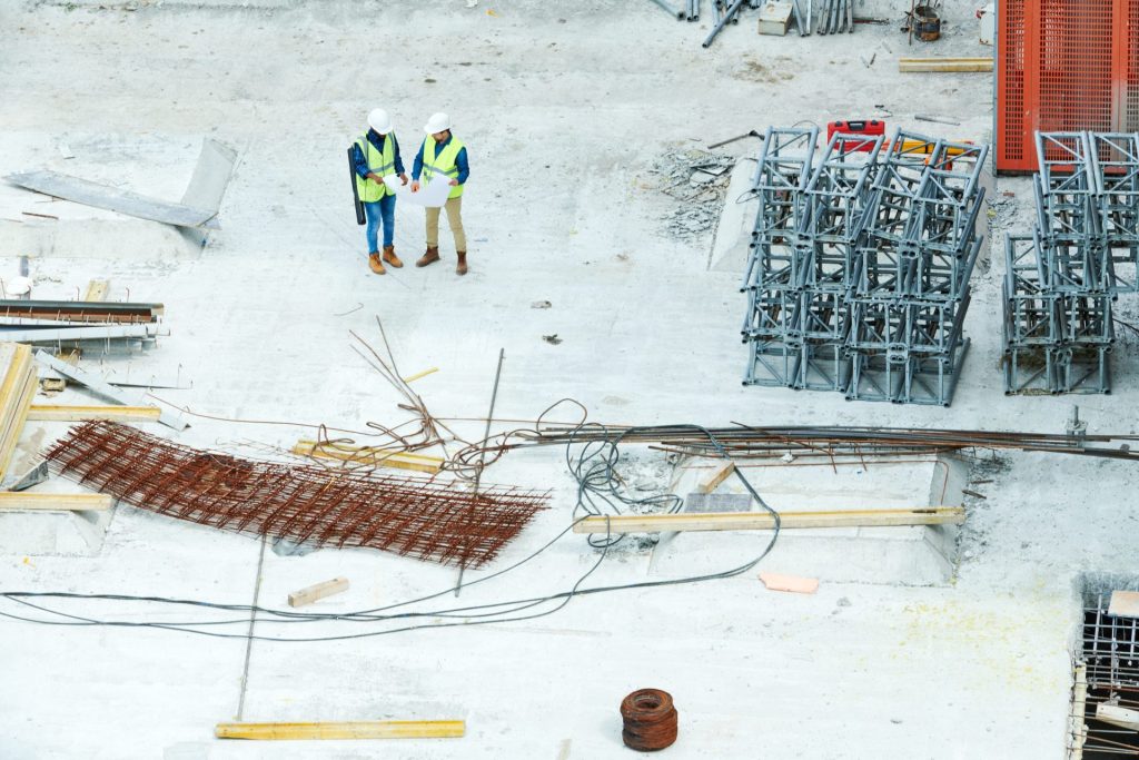 Engineers reviewing plans on a commercial construction site
