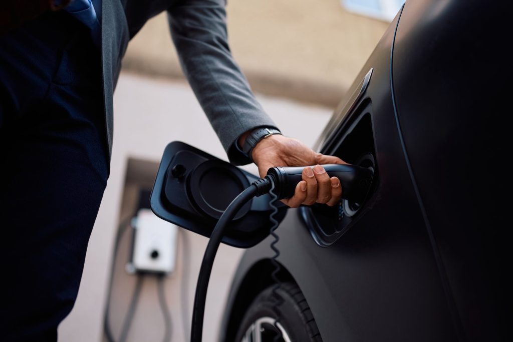 EV charger installation North West electric vehicle charging point being connected to car