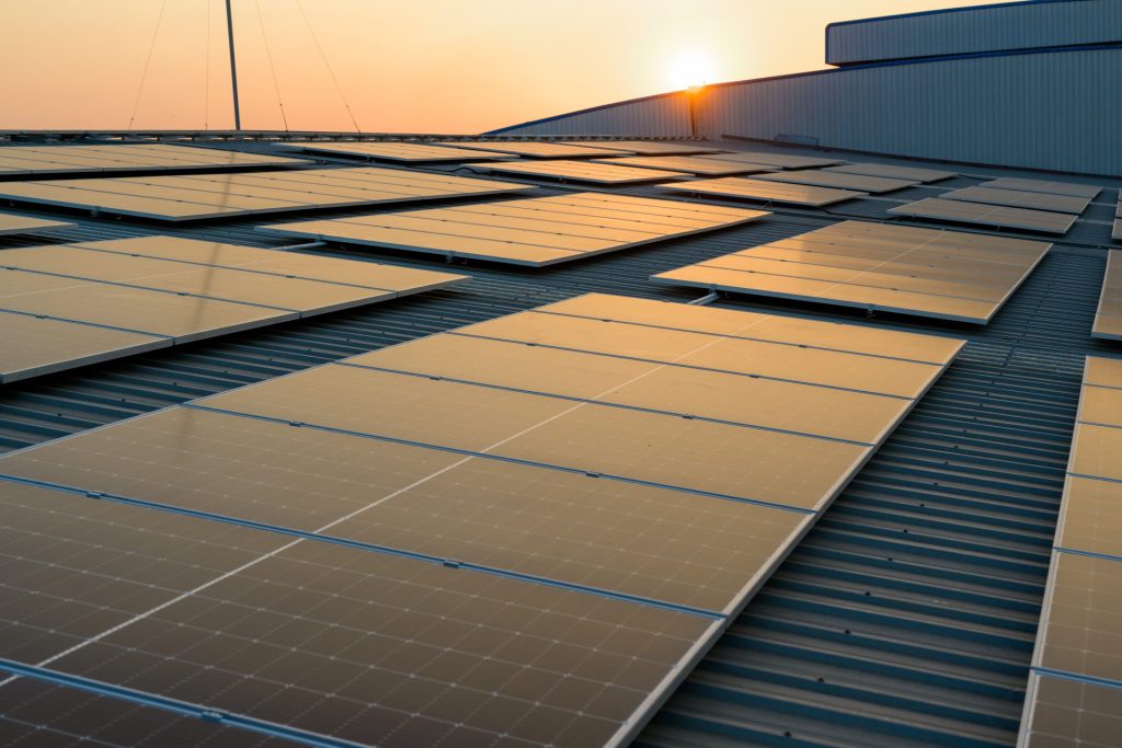 Engineer analysing solar energy production data on tablet at commercial solar installation